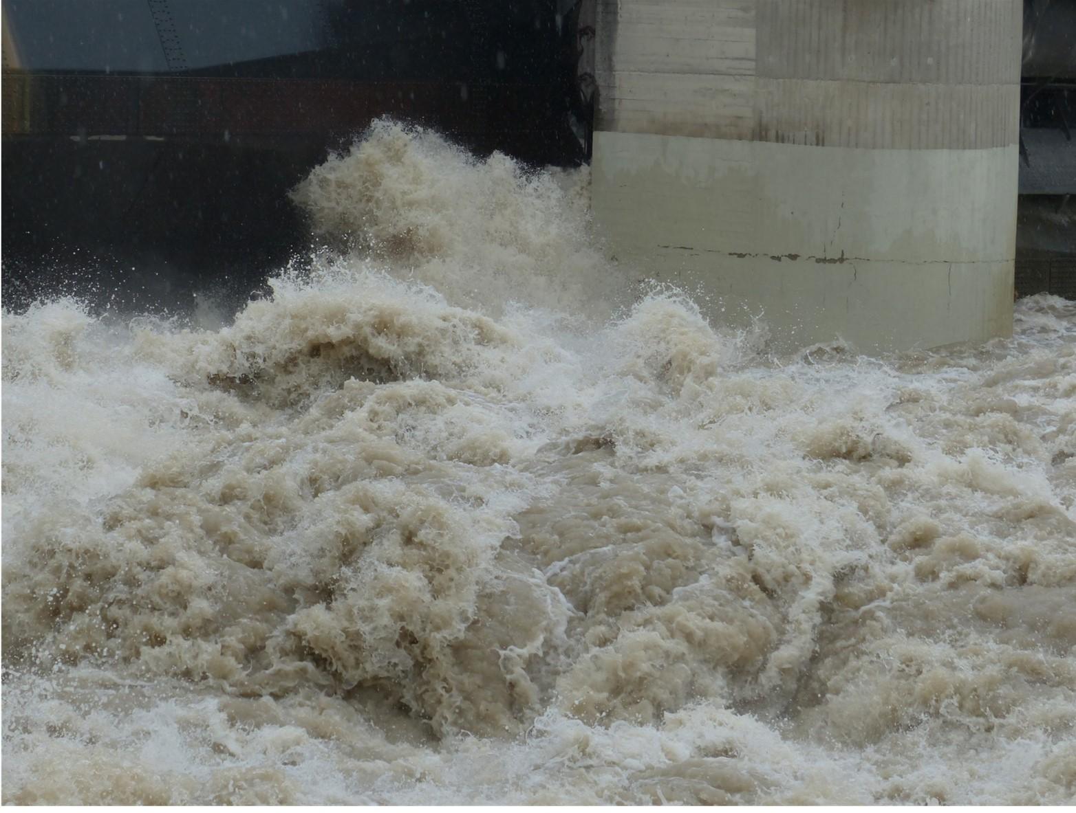 Natual disaster risk mitigation - A large flood of water overwhelming a landscape, symbolising the devastation caused by natural disasters and the importance of proactive risk mitigation strategies.