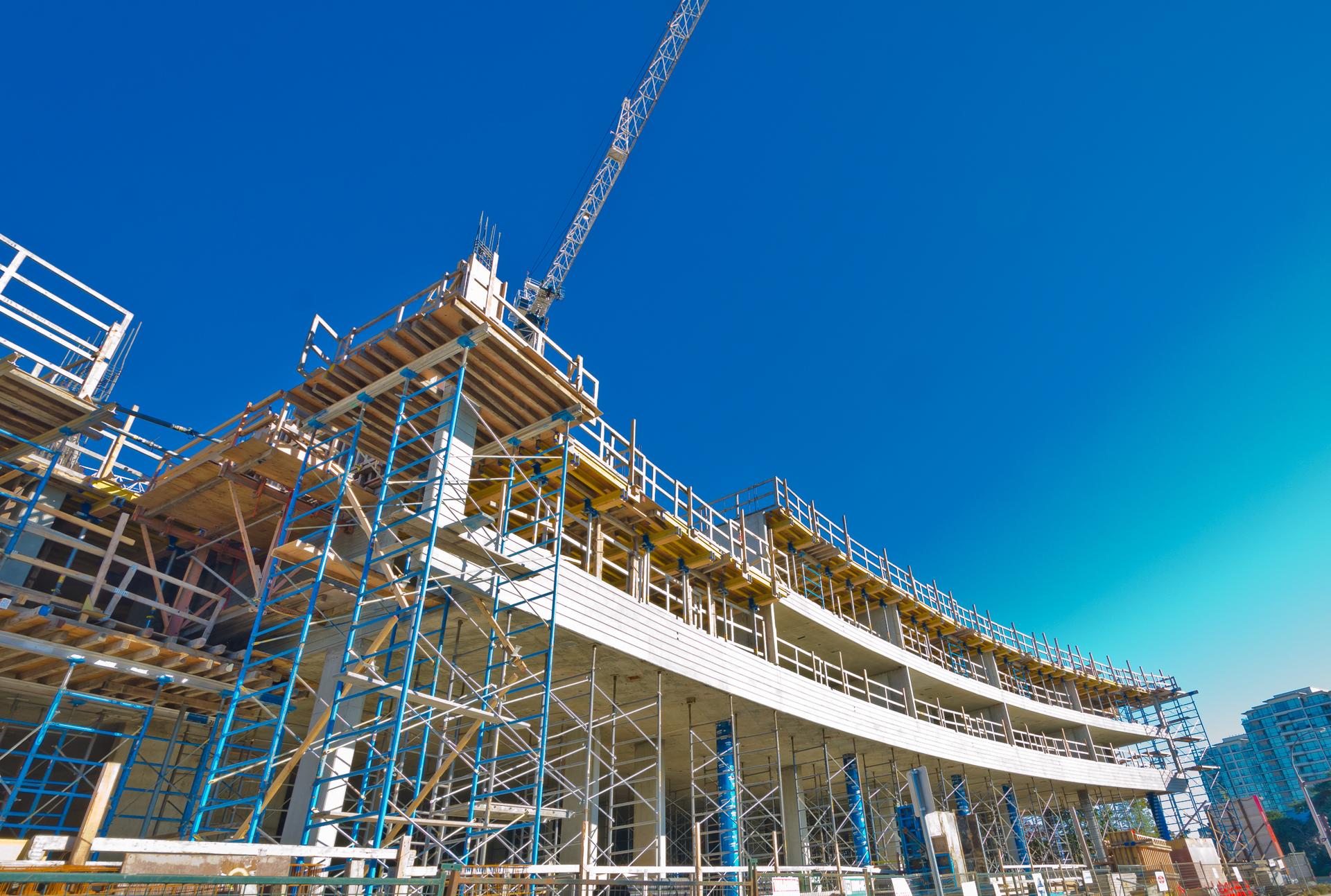 Financing Construction Projects - Commercial building under construction, featuring scaffolding and cranes, symbolising growth and business development.