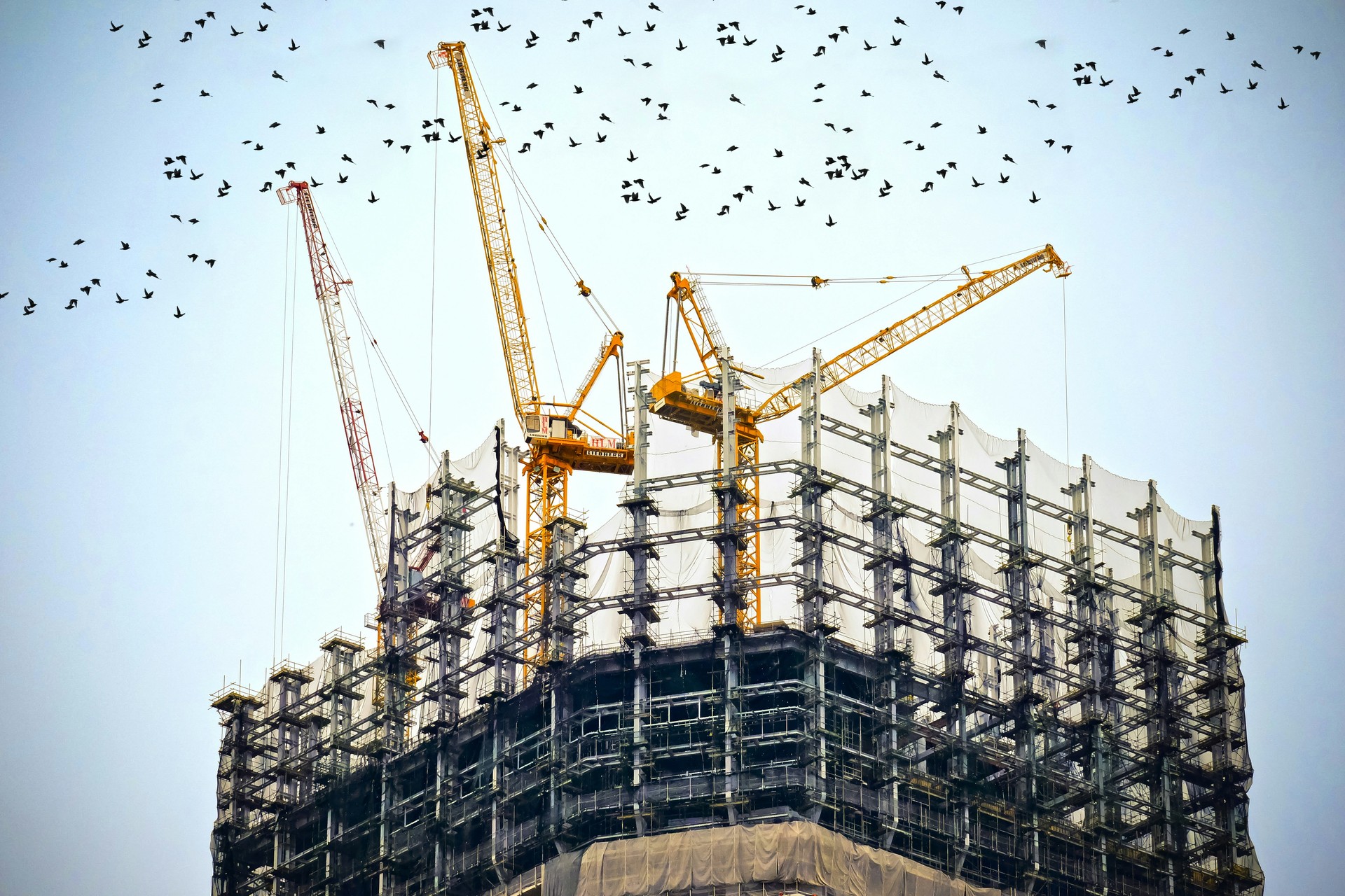 A construction site with workers and machinery, symbolising the importance of securing construction projects with bonds and guarantees insurance